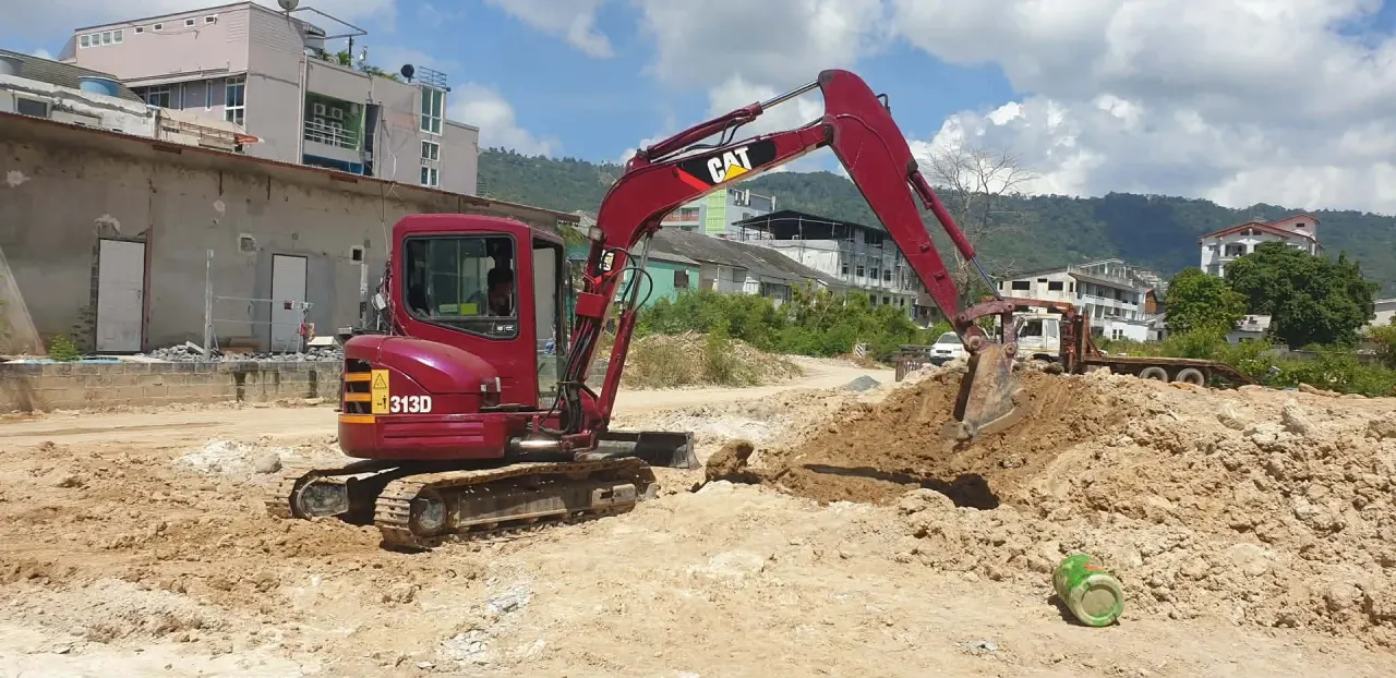 Excavator clearing and removing excess soil from the building site