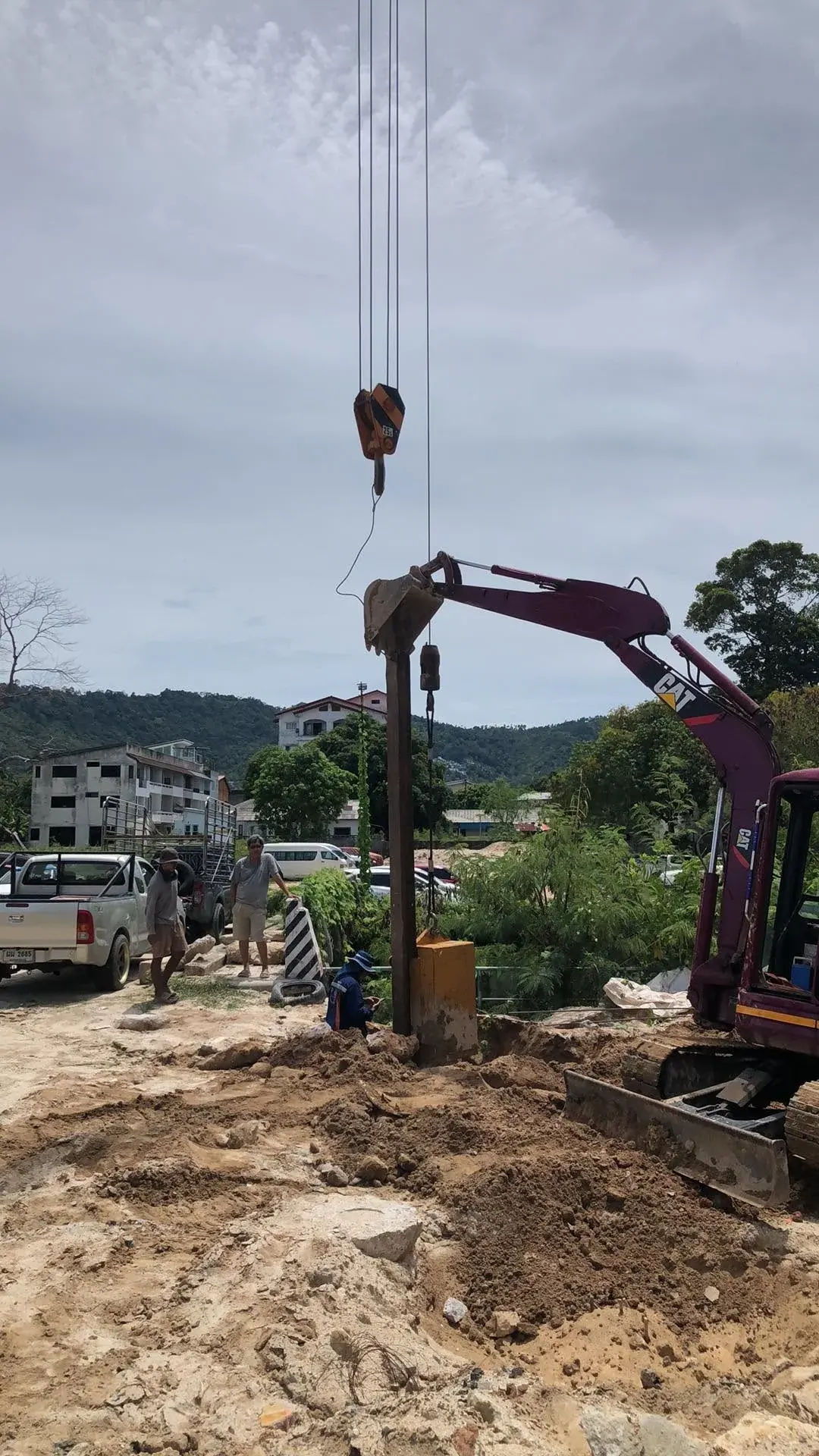 Working alongside a crane to position and install foundation piles