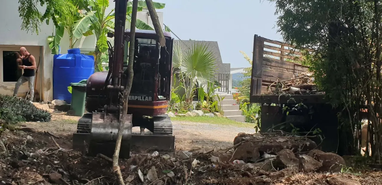 Loading cleared vegetation and debris into the truck for removal