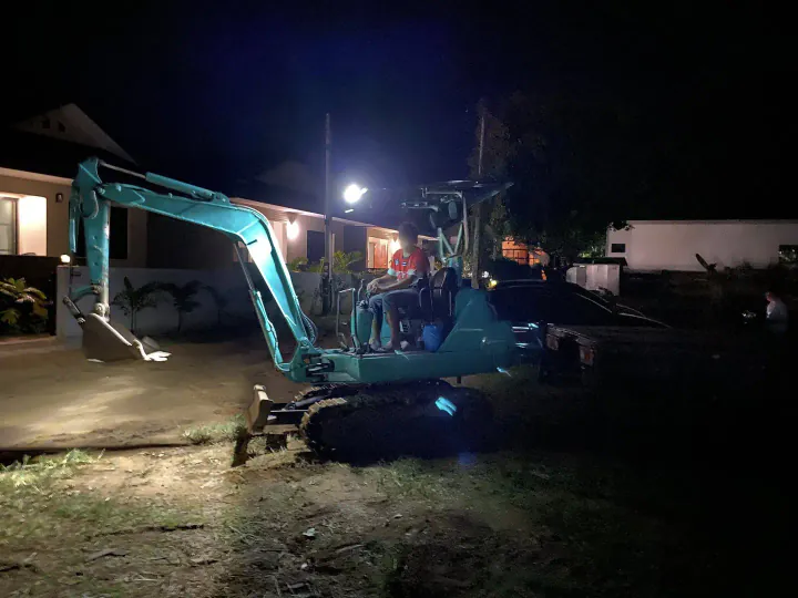 Excavator working on site in the evening