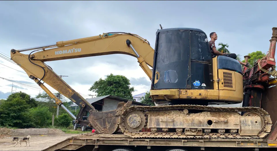 Transporting excavator on lowbed trailer between job sites